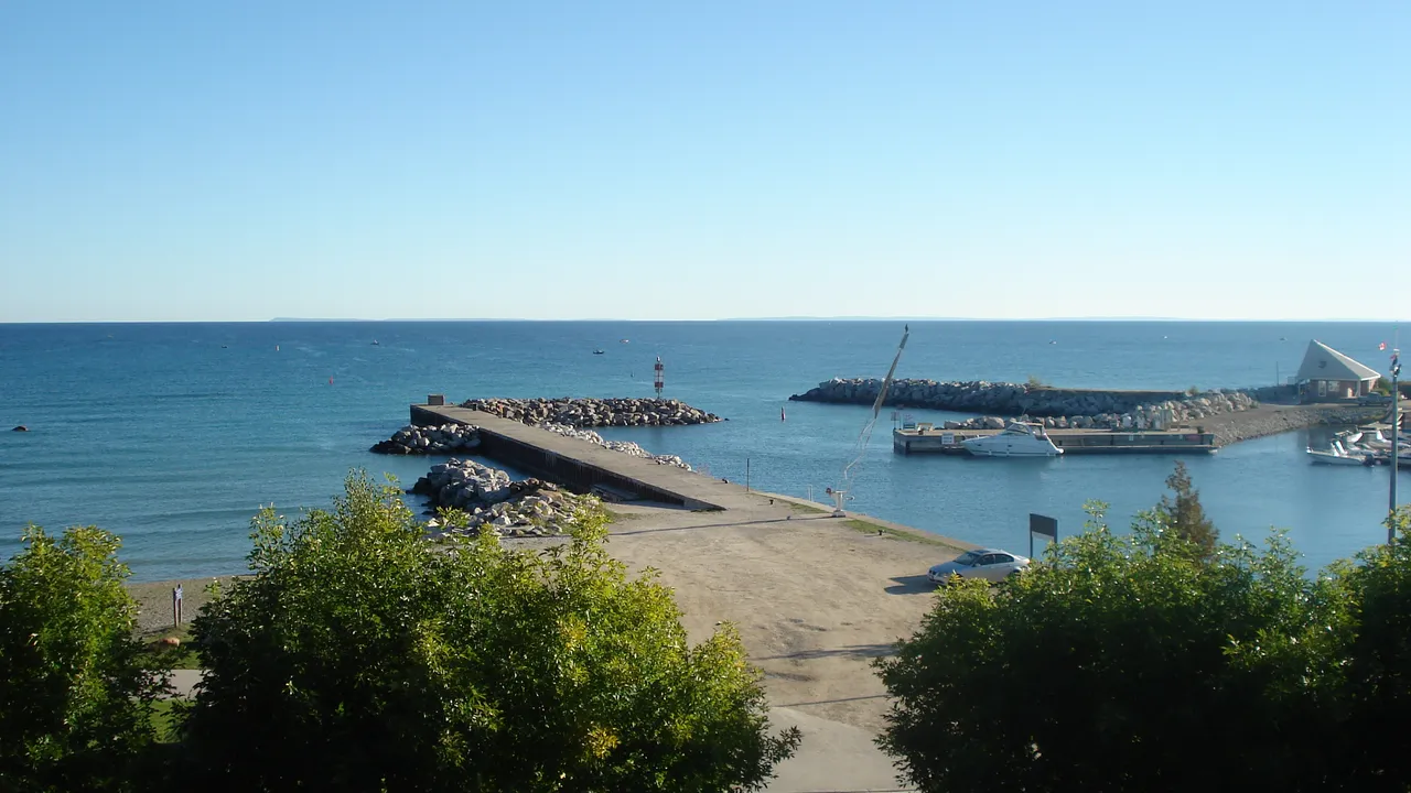 The Thornbury harbour pier reaching into the blue water of Georgian Bay.