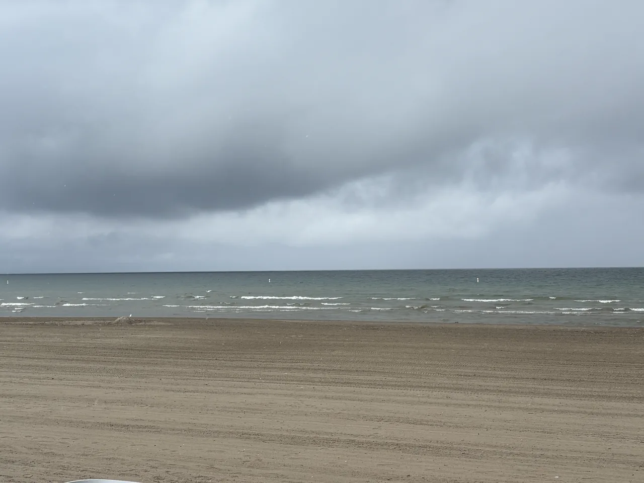 The wide sandy expanse of Wasaga Beach, the world's longest freshwater beach, meeting Nottawasaga Bay.