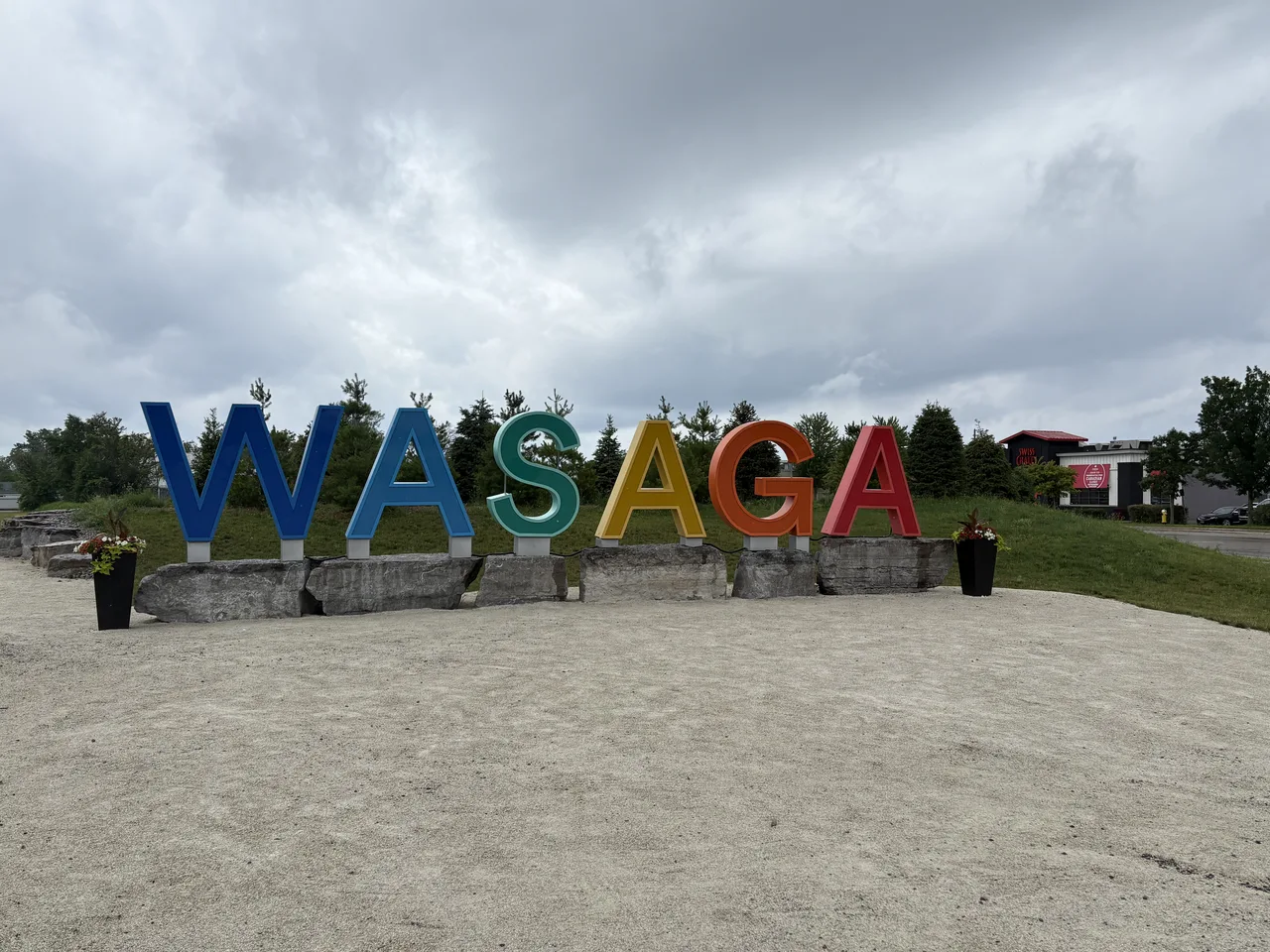 The colourful WASAGA letter sign on the sand at the entrance to Wasaga Beach, Ontario.