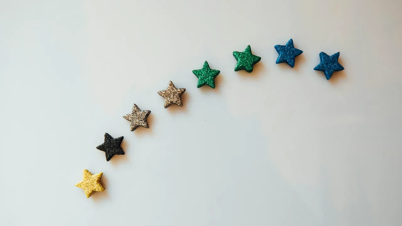 A curve of small coloured stars on a white background.