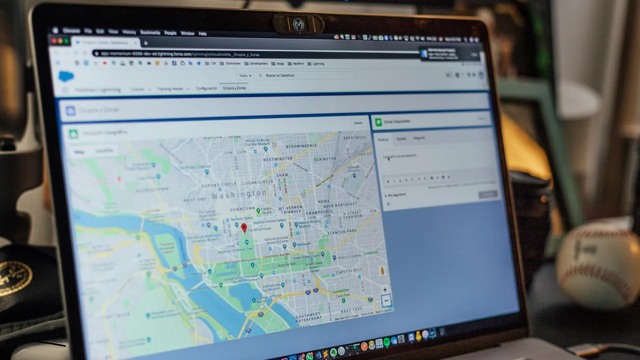 A laptop on a desk showing a city map in the browser.