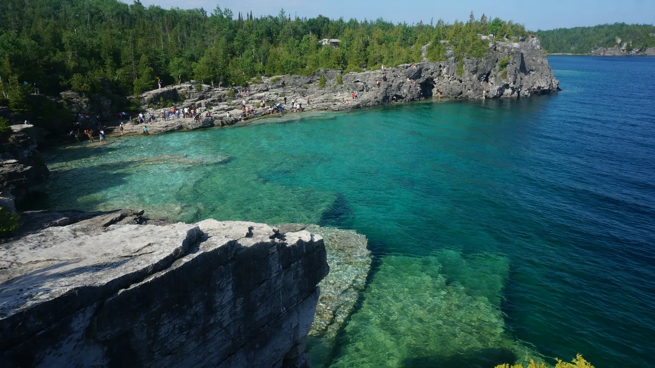 Clear turquoise water below the limestone cliffs at the Grotto, Tobermory, on the Bruce Peninsula.